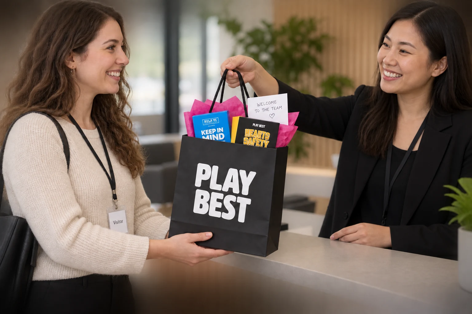 A new employee receiving a PlayBest gift bag from a colleague